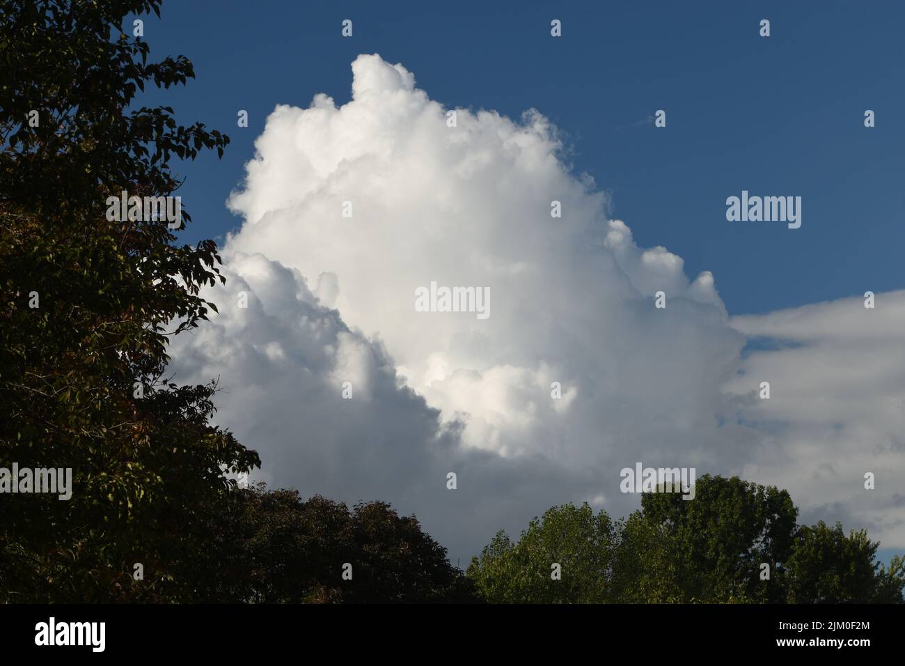 A beautiful view of white clouds in the blue sky over a landscape with ...