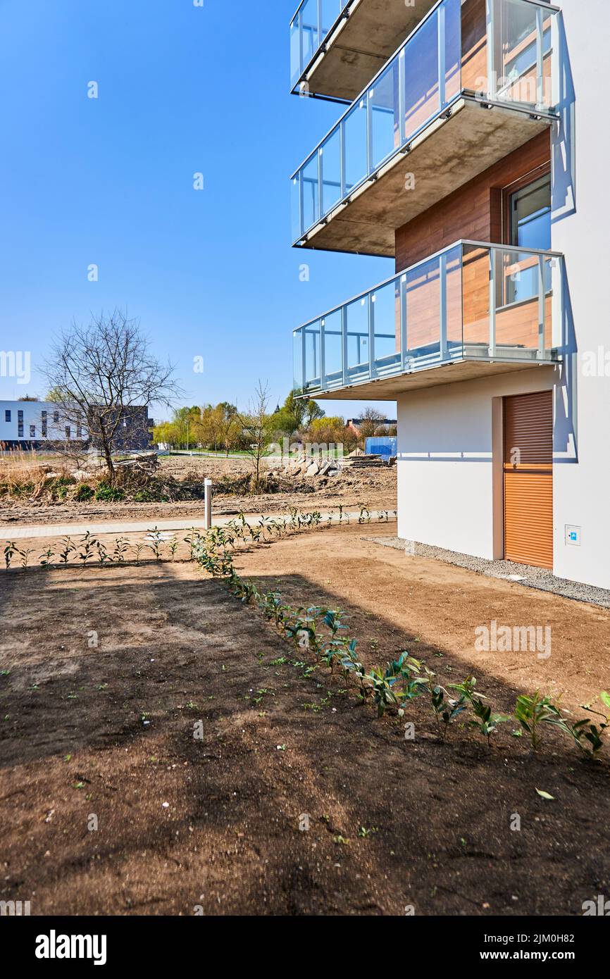 A vertical shot of newly created garden area by modern apartment