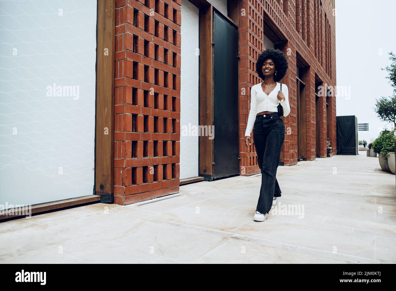 Portrait of attractive young woman walking outside in the city Stock ...