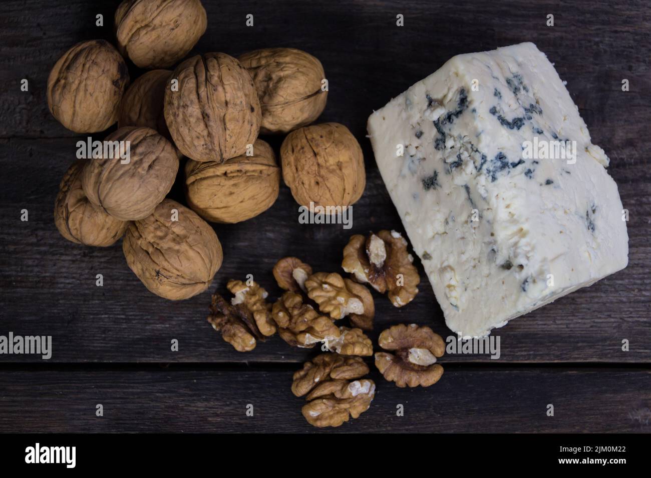 roquefort cheese with walnuts on dark background Stock Photo