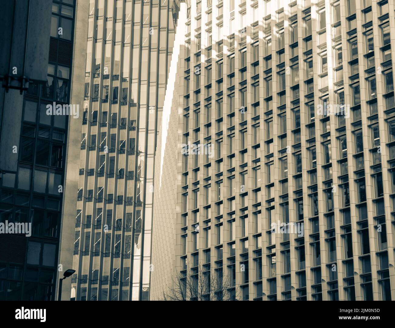 The facade of a modern building with glass windows under the sunlight ...