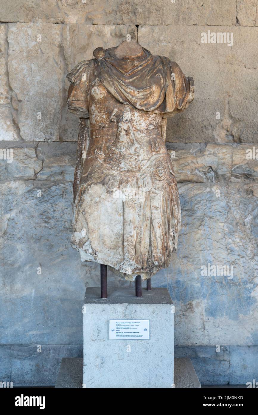 A vertical shot of an Athens headless sculpture in front of a building