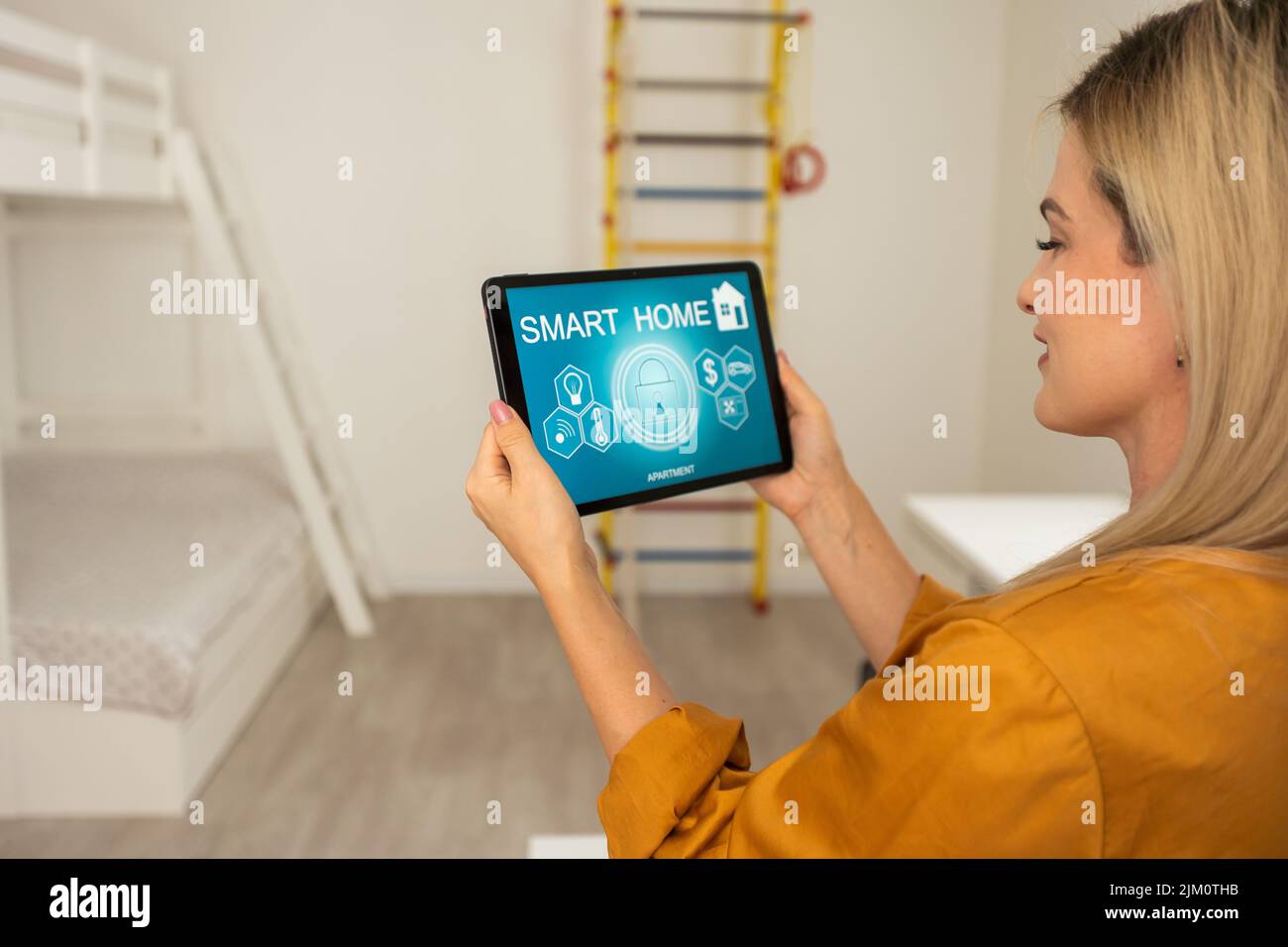 Woman at home using smart screen, automation domestic system. Stock Photo