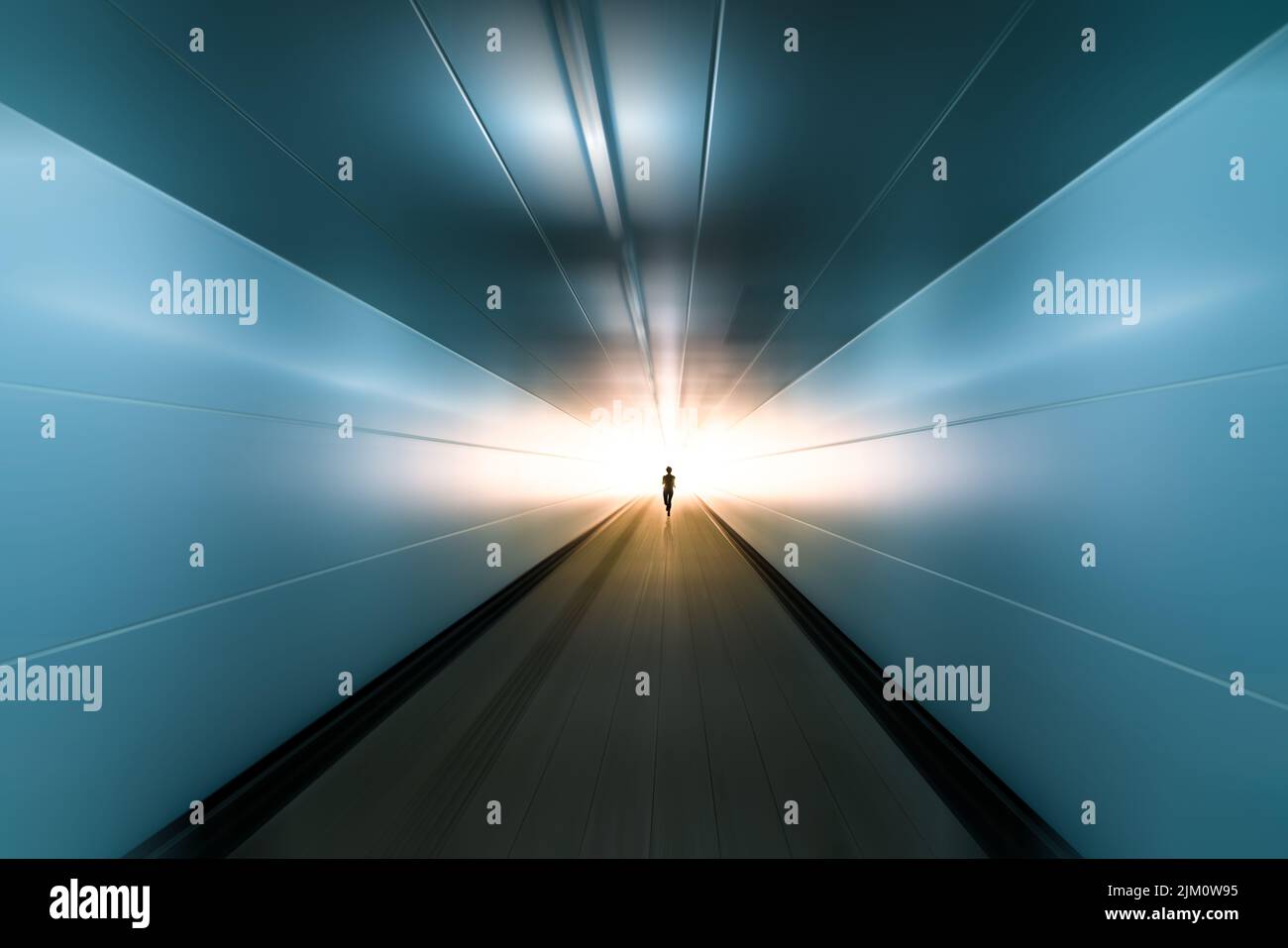 silhouette of running man toward ending with sunshine ahead in motion blurred tunnel, business success concept. Stock Photo