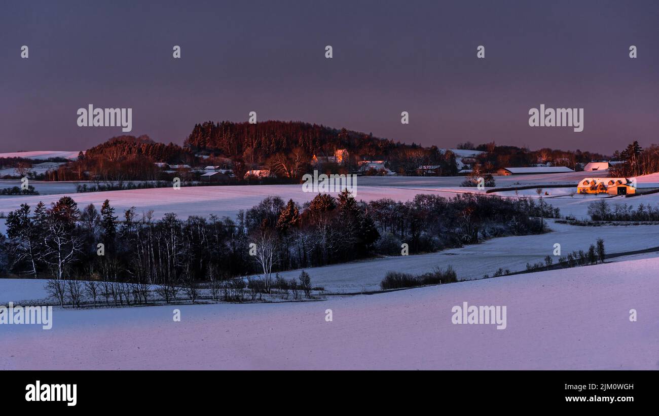 Snowy landscape illuminated by the first rays of the sun of a cold spring dawn. Assens, Fyn, Denmark, Europe Stock Photo