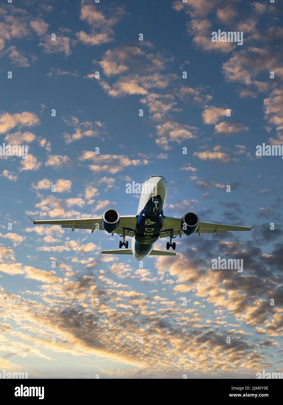 An airplane flying in the sky Stock Photo - Alamy