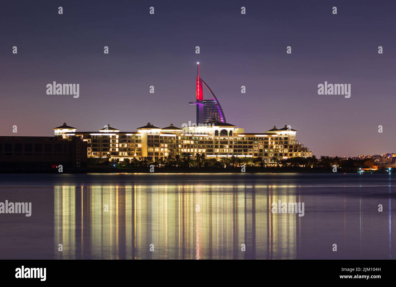 A beautiful shot of Burj Al Arab and Waldorf Astorias Hotel at night in Dubai Palm Jumeirah, United Arab Emirates Stock Photo