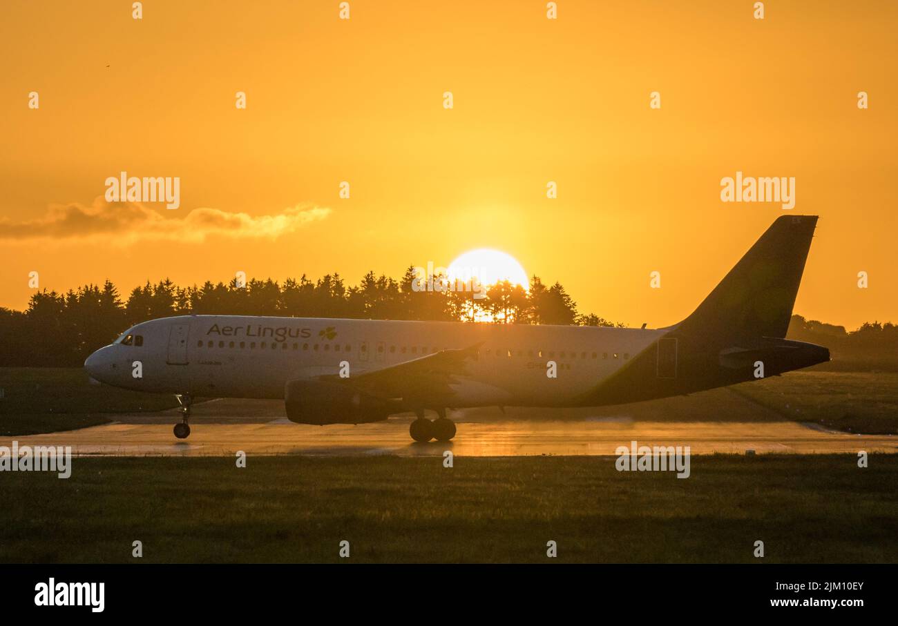 Cork Airport, Cork, Ireland. 04th August, 2022. An Amsterdam bound Aer Lingus Airbus A320 gathers speed down the runway at sunrise for its early morning flight from Cork Airport, Ireland.  - Credit; David Creedon / Alamy Live News Stock Photo