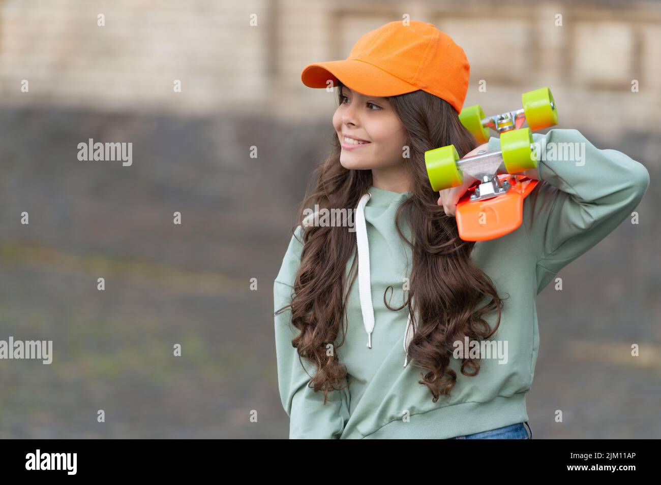 teen girl skater with skateboard. girl with penny board. hipster girl with longboard. copy space. Stock Photo