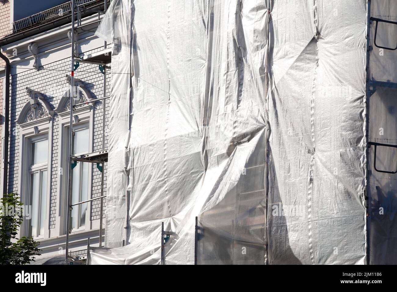 White tarpaulin, construction site, scaffolding, house facade, Germany Stock Photo