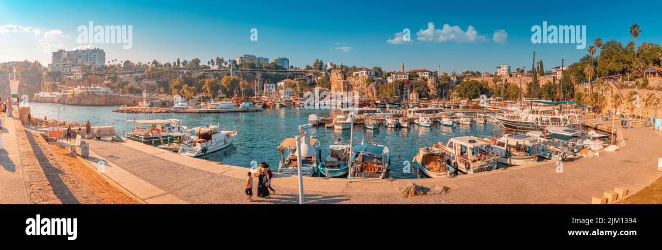21 June 2022, Antalya, Turkey: Panoramic view of the picturesque bay with marina port with yachts and cruise tourist ships near the old town of Kaleic Stock Photo