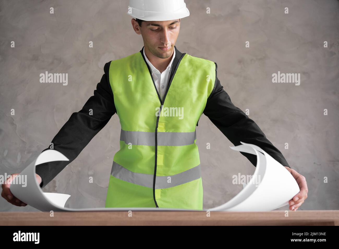 Male arabic engineer with drawing on grey background, Stock Photo