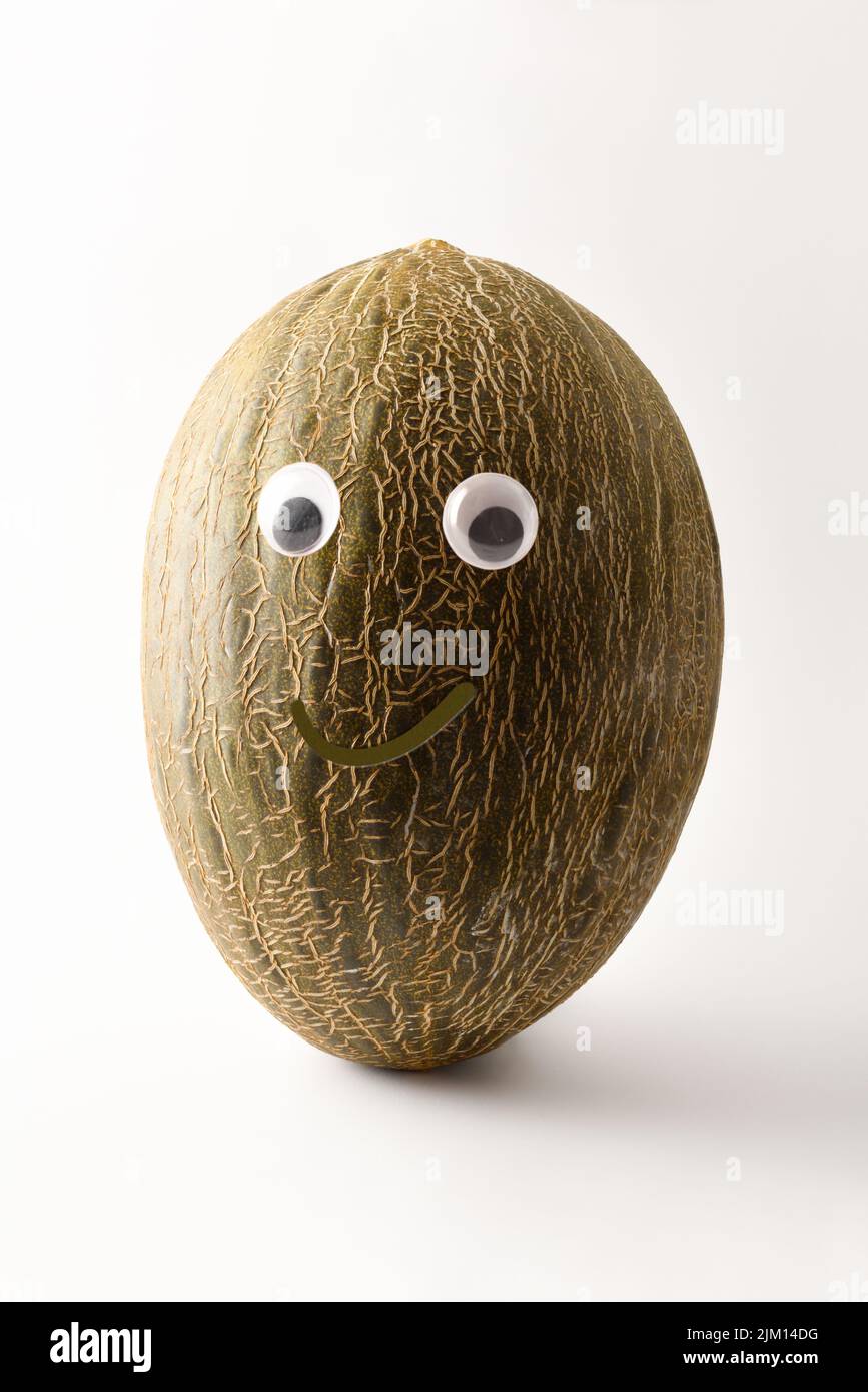 Healthy melon with face on white isolated background. Fruits and