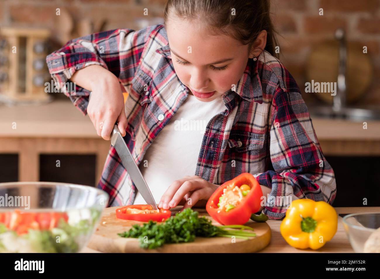 child cooking skills girl learn cut vegetable Stock Photo Alamy