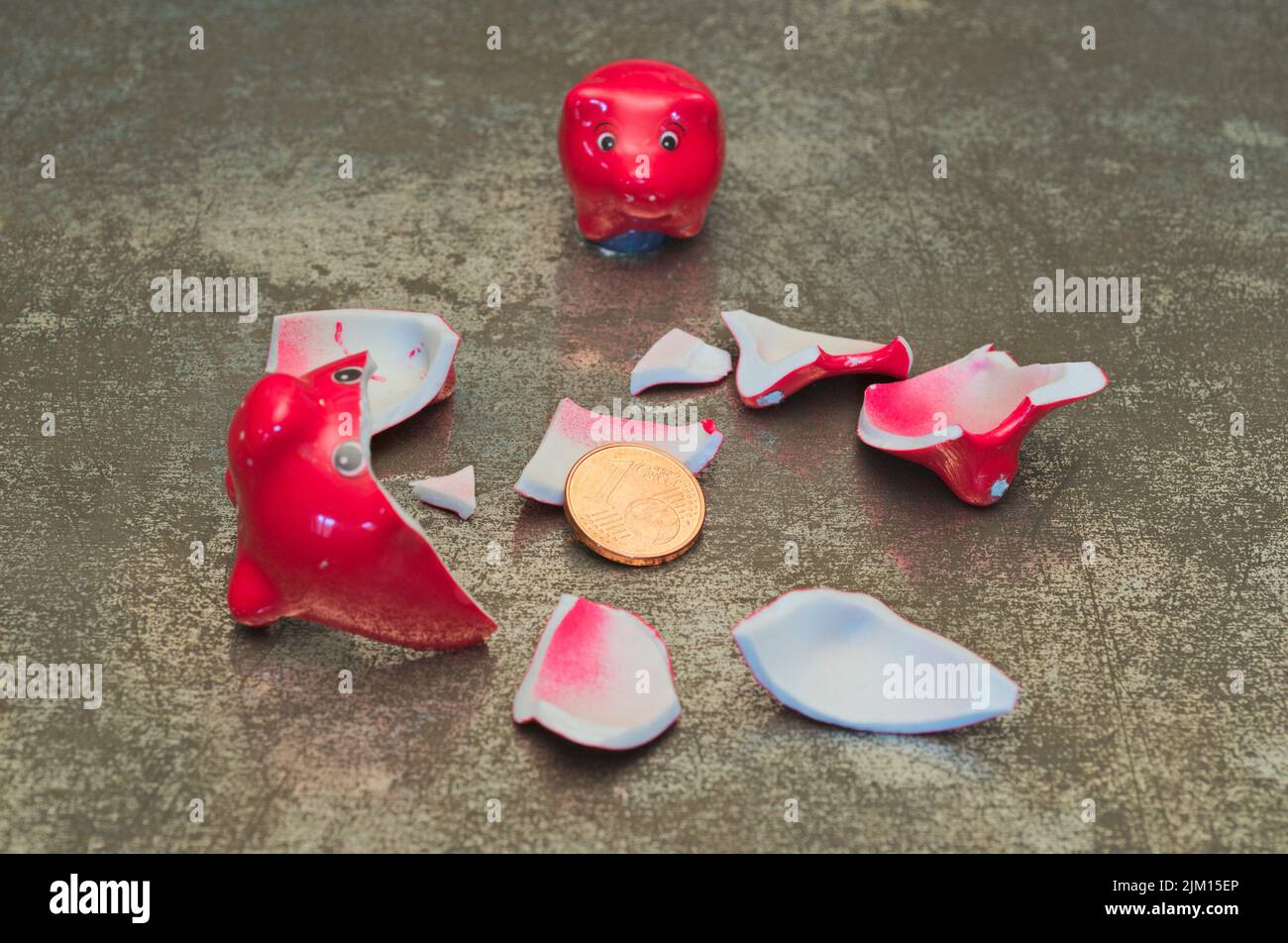 Red Smashed Piggy Bank with one cent Stock Photo