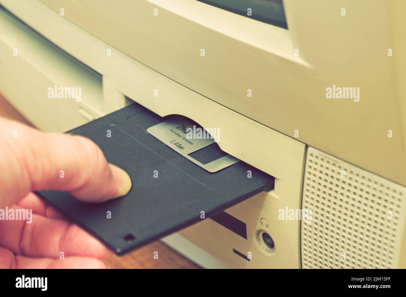 loading a floppy disk into disk drive Stock Photo