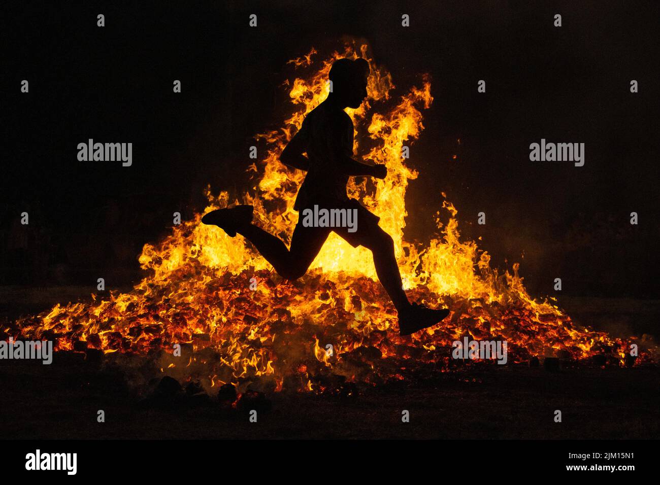 Summer solstice celebration jumping into the fire. Burning flames
