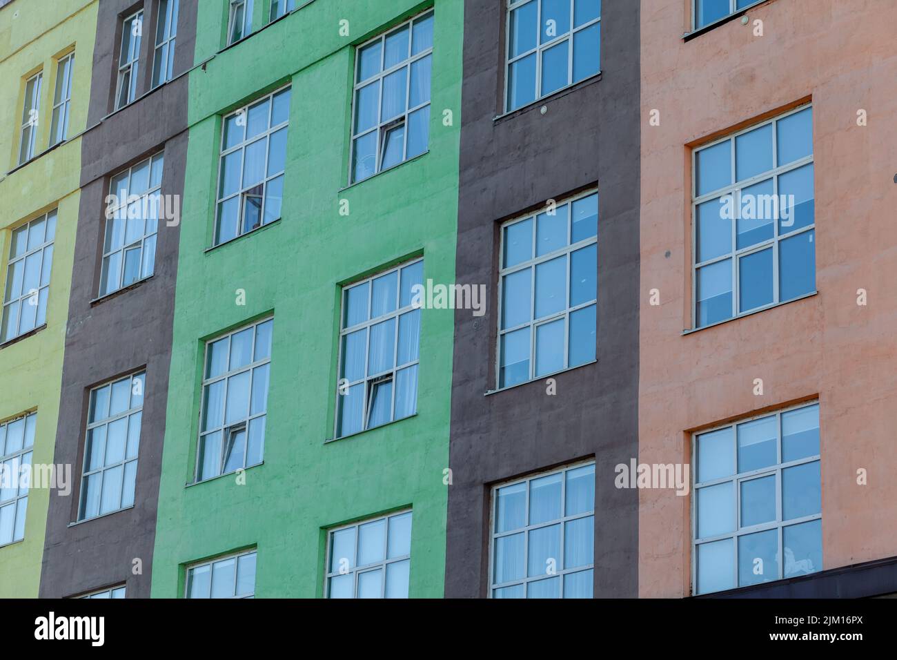 The exterior of a tall building with windows. A newly built building