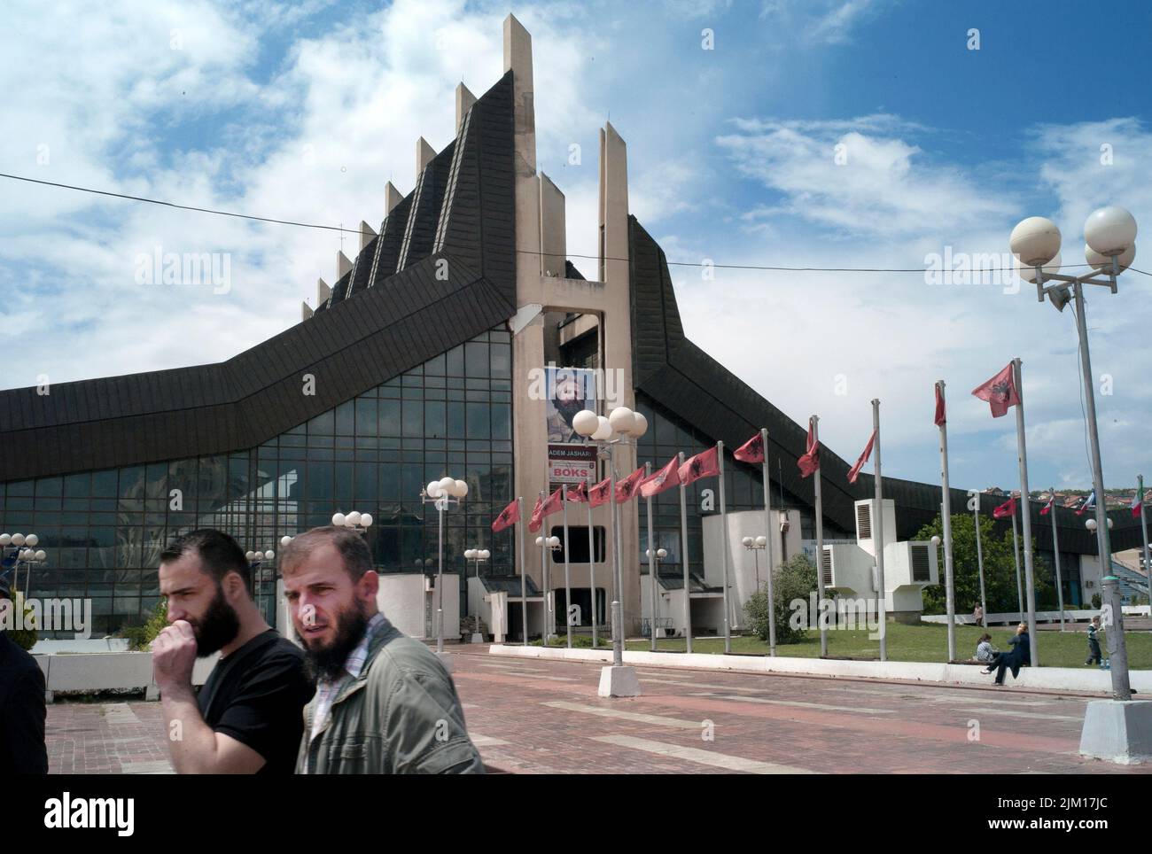 Pristina, Kosovo. posters and flags celebrate a freedom fighter from the Kosovo Liberation Army, outside the Yugoslav-era sports centre. Stock Photo