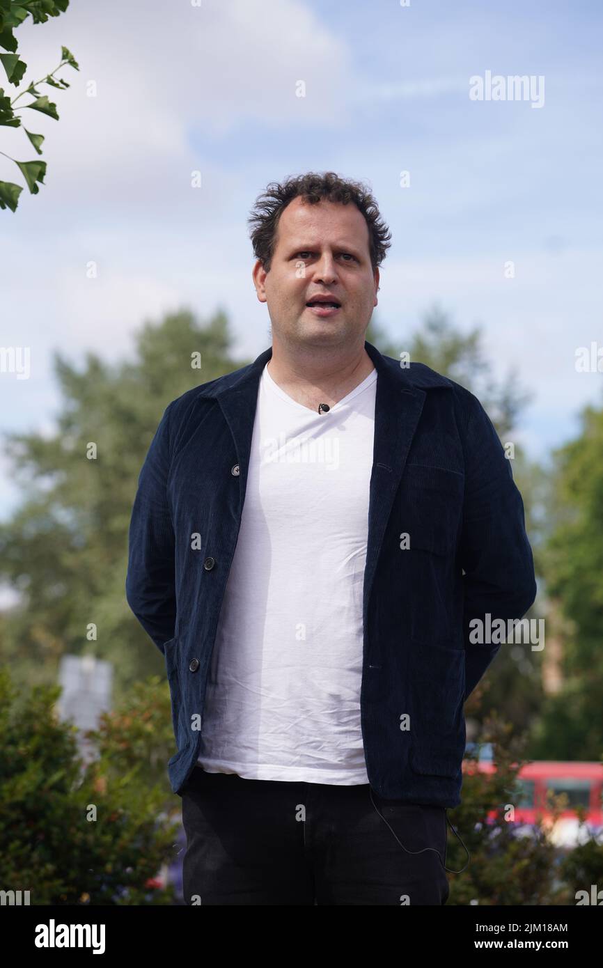 Doctor and best-selling author Adam Kay, who wrote BBC hospital drama This Is Going To Hurt, plants a tree at Ealing Hospital, west London, in commemoration of NHS staff who have taken their own lives. Kay's BBC drama features a moving scene where a tree is planted in memory of character Shruti, a doctor who committed suicide. After contact with the real-life hospital's CEO a memorial tree will now stand permanently on the hospitals grounds. Picture date: Thursday August 4, 2022. Stock Photo