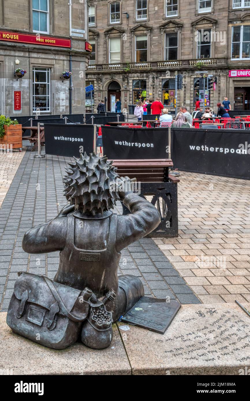 Statue by Malcolm Robertson of the cartoon character Oor Wullie in Dundee, appears to be firing his pea shooter at a Wetherspoon's pub. Stock Photo