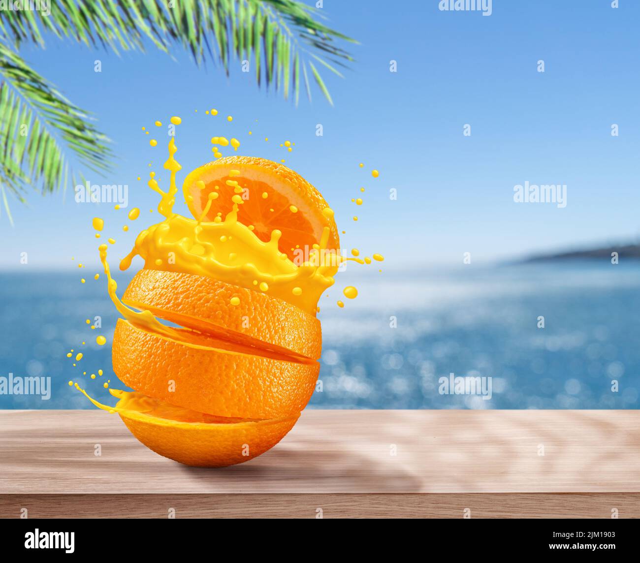 Juicy sliced orange with orange splash. Blue sparkling sea at the background. Stock Photo
