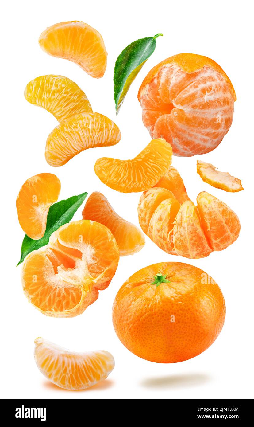 Levitating ripe tangerine fruits, leaves and mandarin slices on white background. File contains