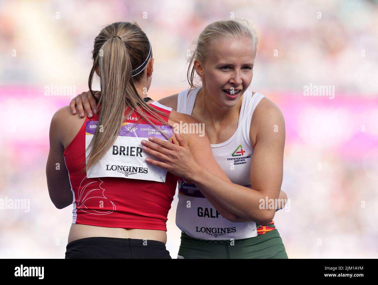 Guernsey's Abi Galpin (right) and Wales' Hannah Brier after heat three of the first round of the Women's 100 metres at Alexander Stadium on day seven of the 2022 Commonwealth Games in Birmingham. Picture date: Thursday August 4, 2022. Stock Photo