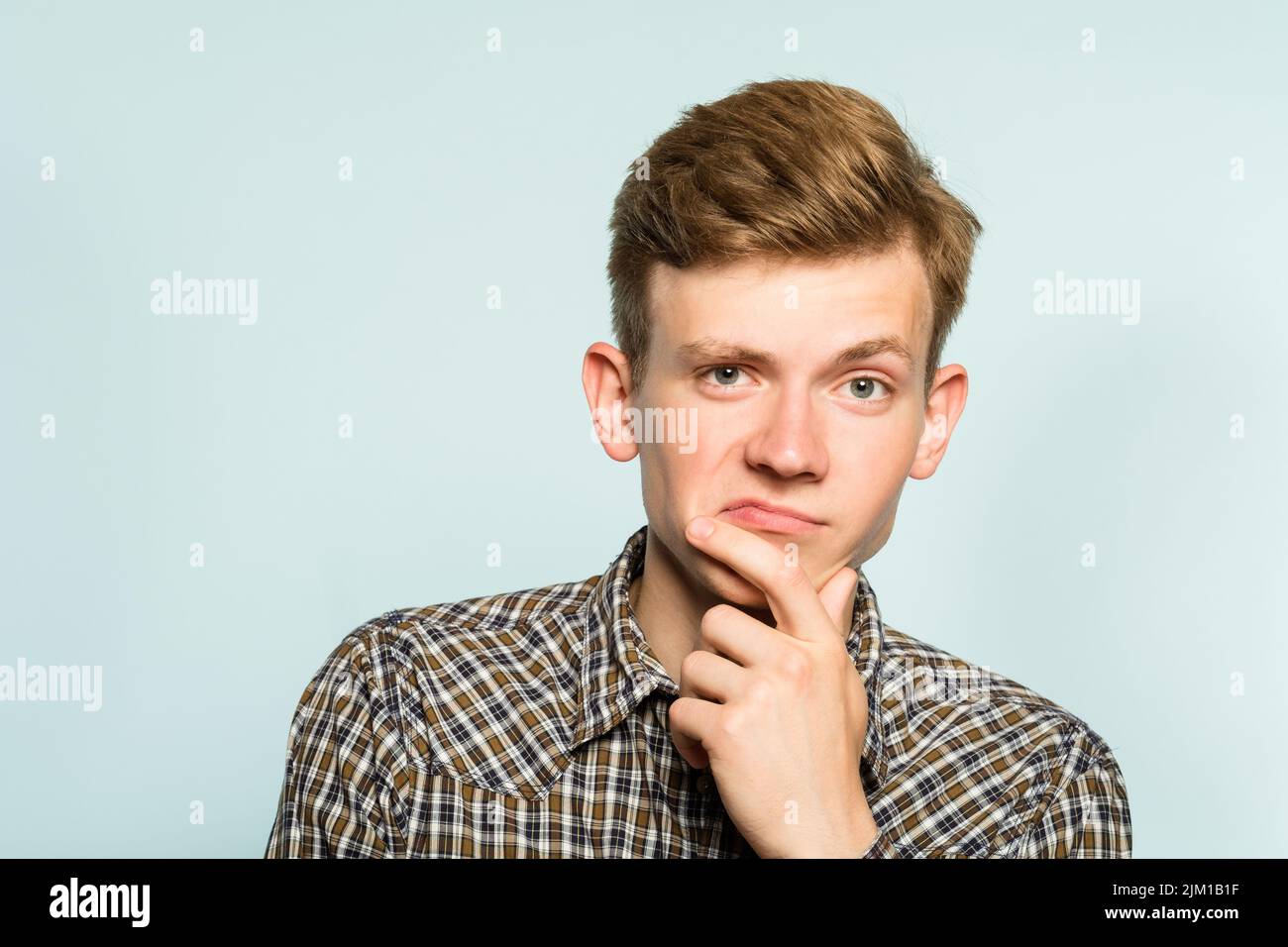 pondering contemplating man thinking scratch chin Stock Photo