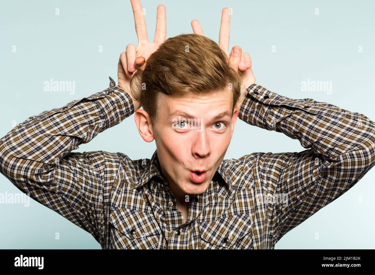 funny amusing comic playful man fooling bunny ears Stock Photo - Alamy