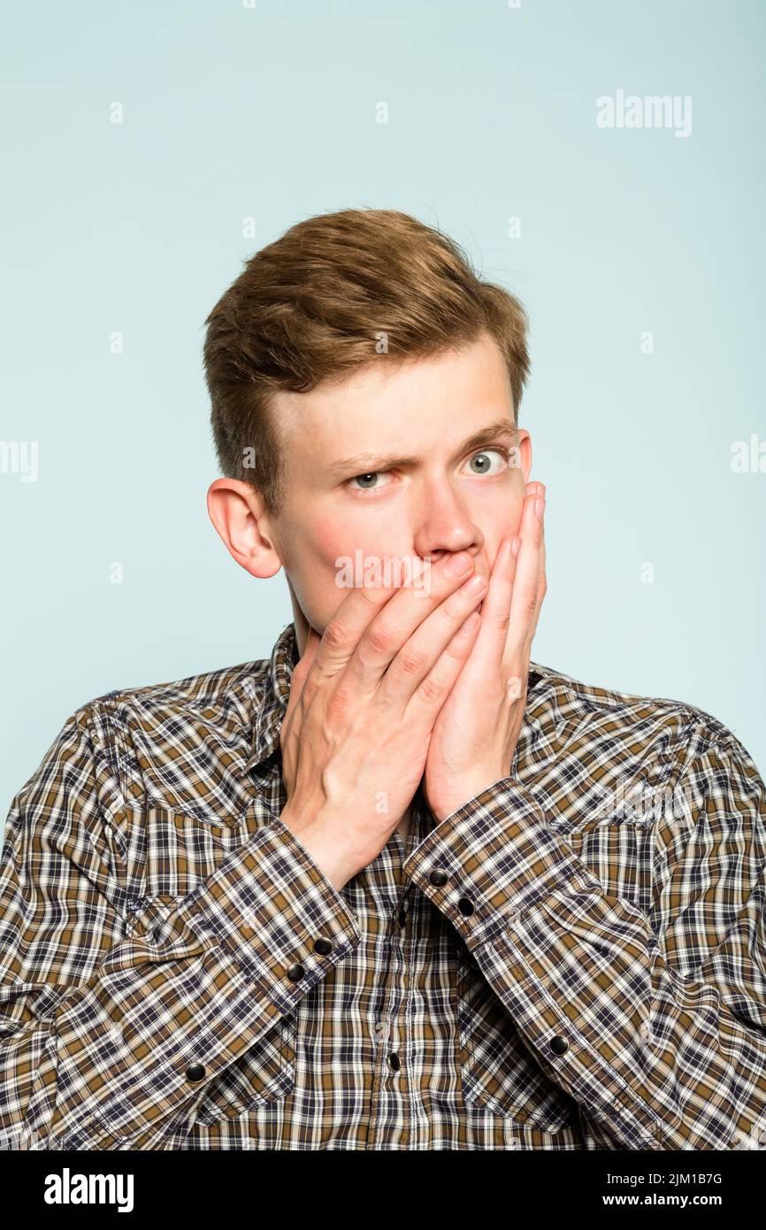 secret mystery man cover mouth hands not speaking Stock Photo