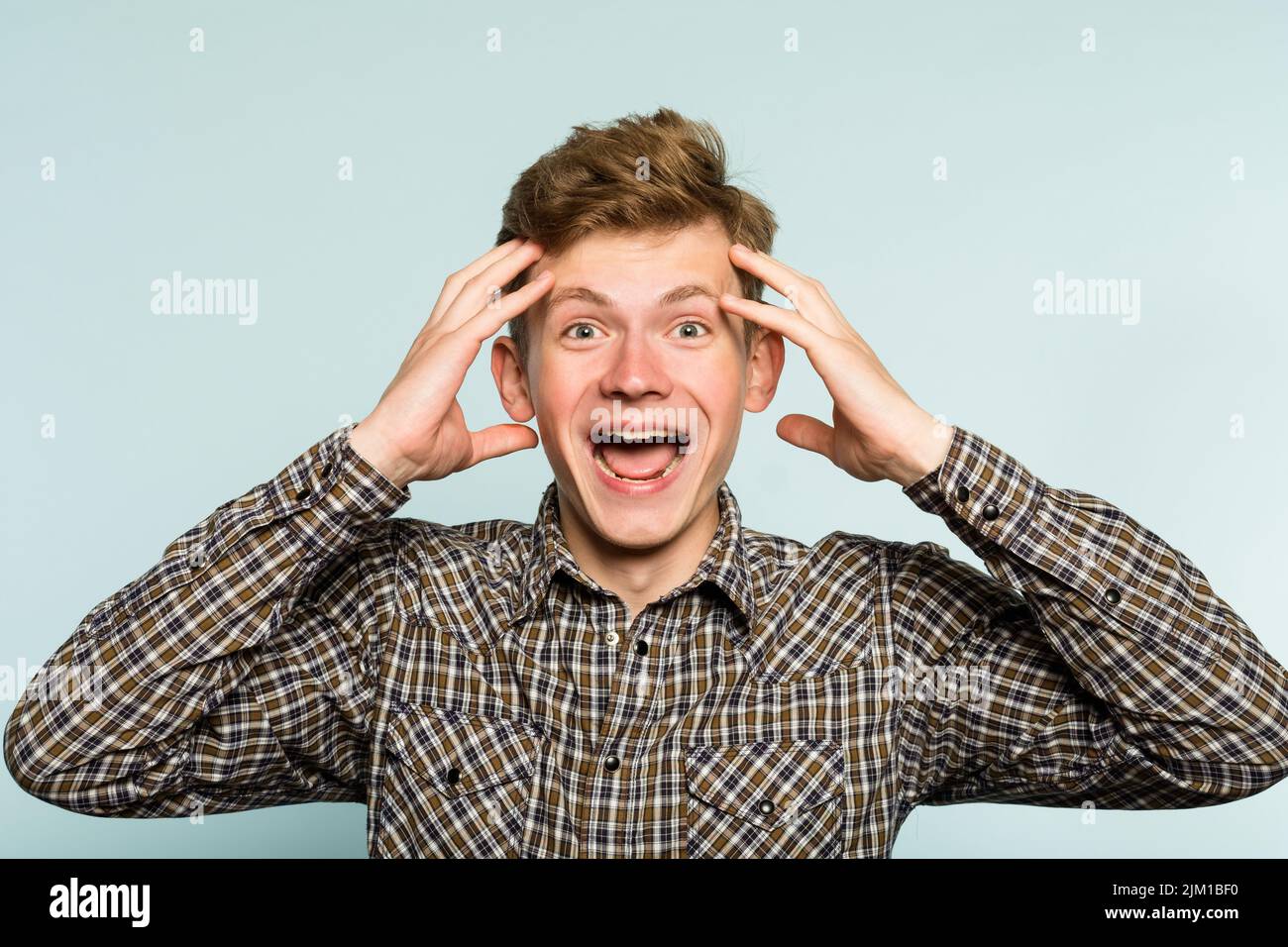 crazy happy overexcited mad wild man wide grin Stock Photo