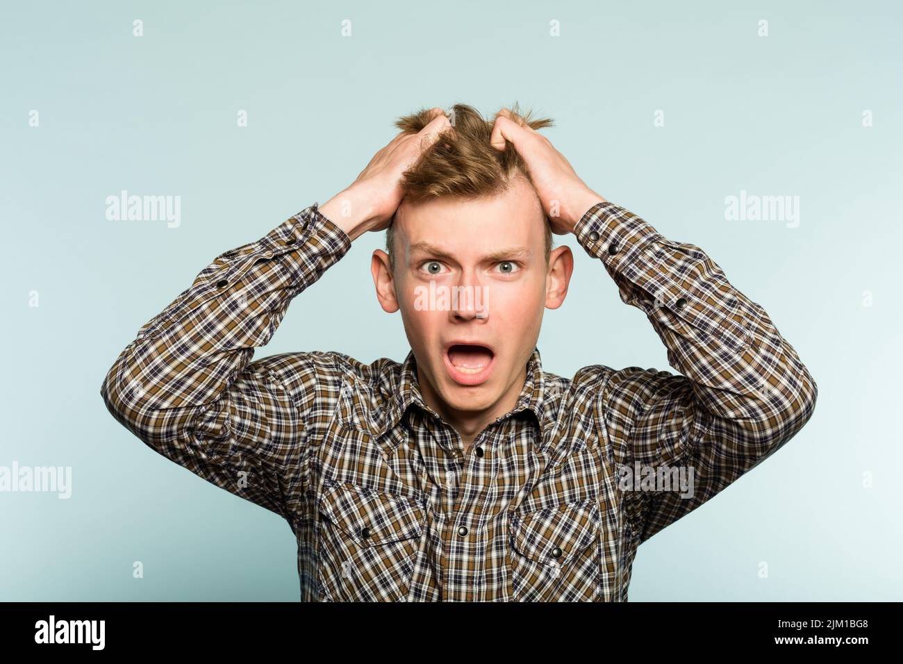 shocked worried distraught man pull hair emotion Stock Photo