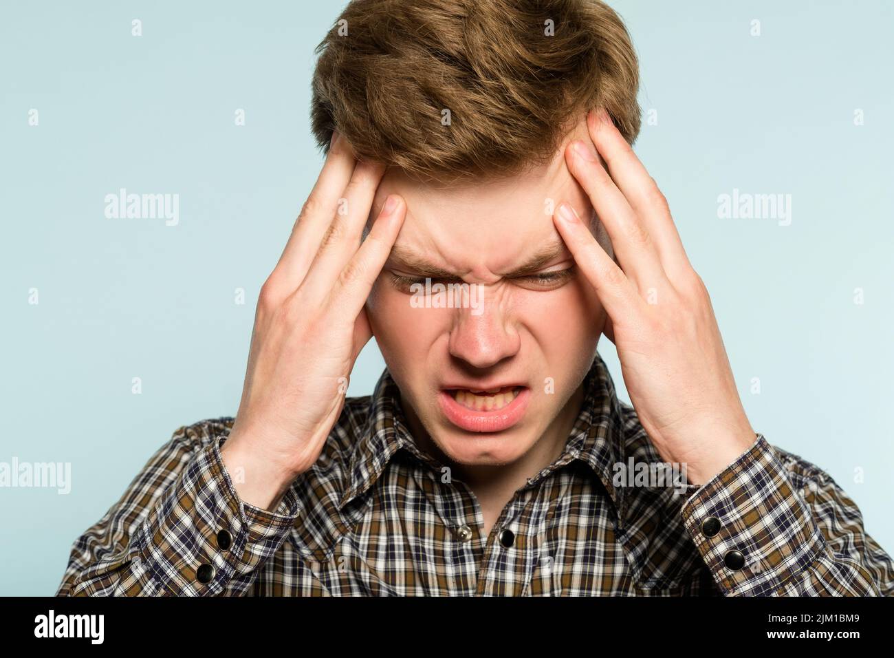 headache migraine man pain clutch head discomfort Stock Photo