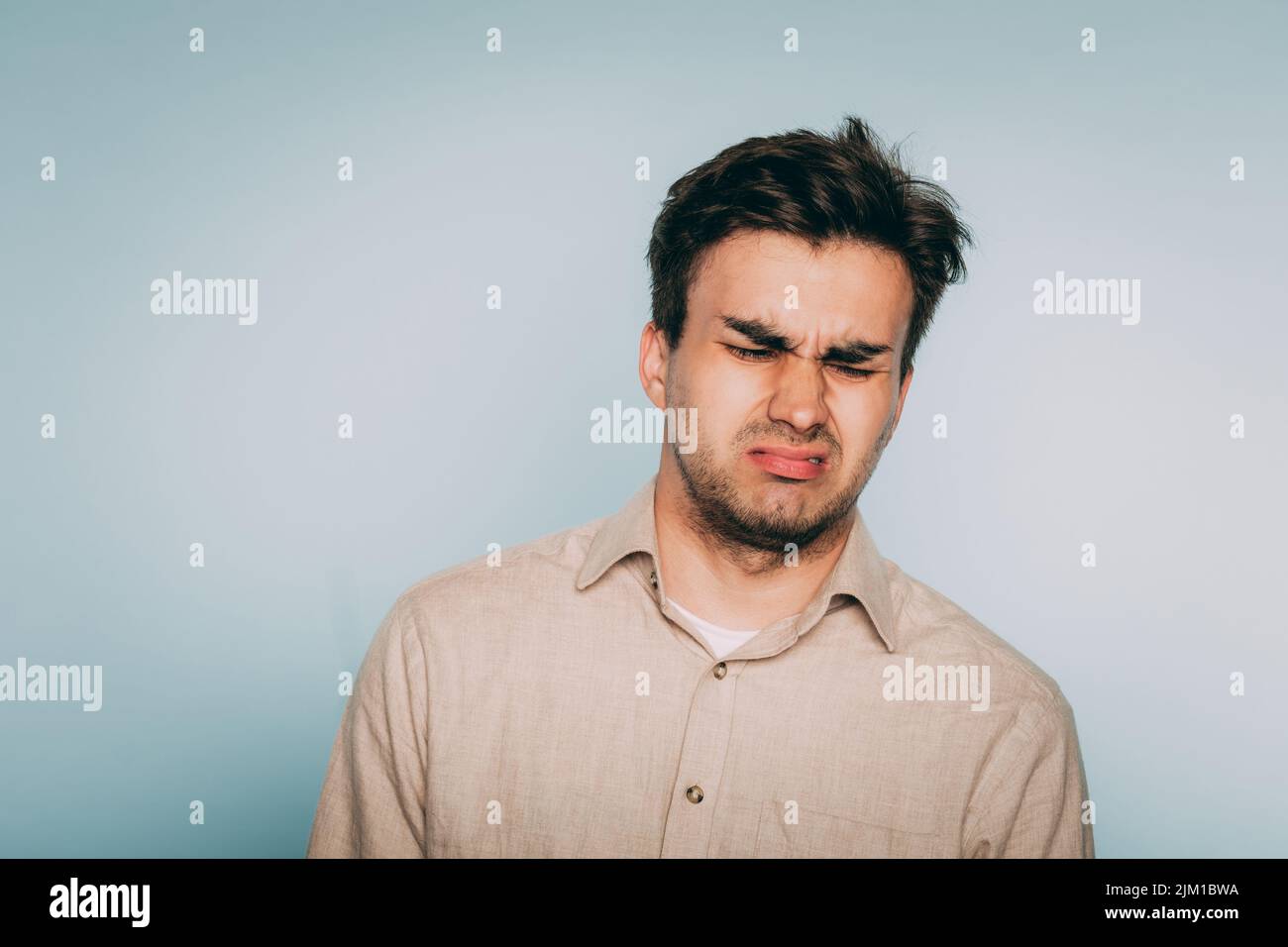nausea repulsion reluctant man grimace disgust Stock Photo