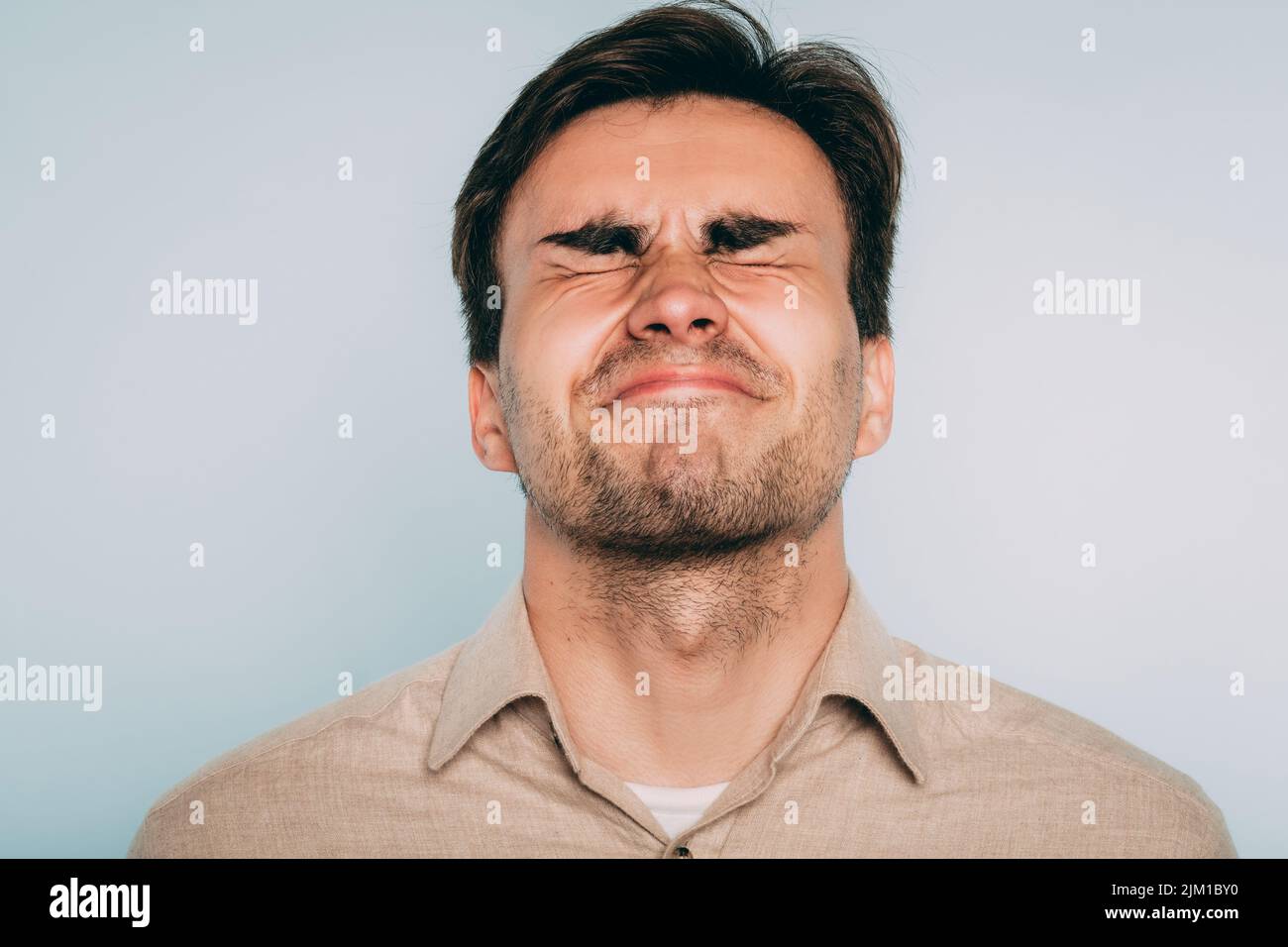 disturbed grimace pain suffer torture man eye shut Stock Photo