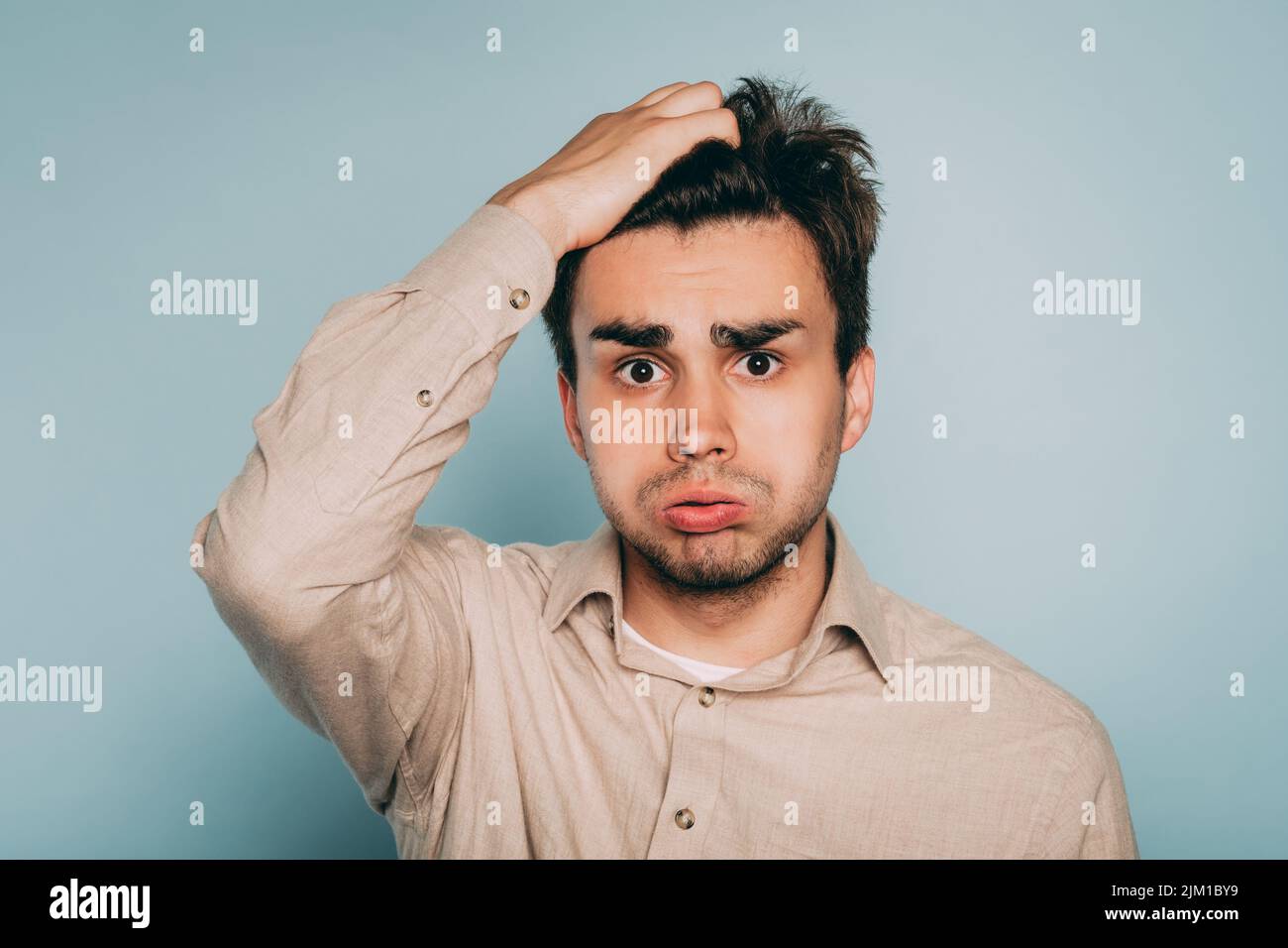 overwhelmed dizzy confused man hold head emotion Stock Photo