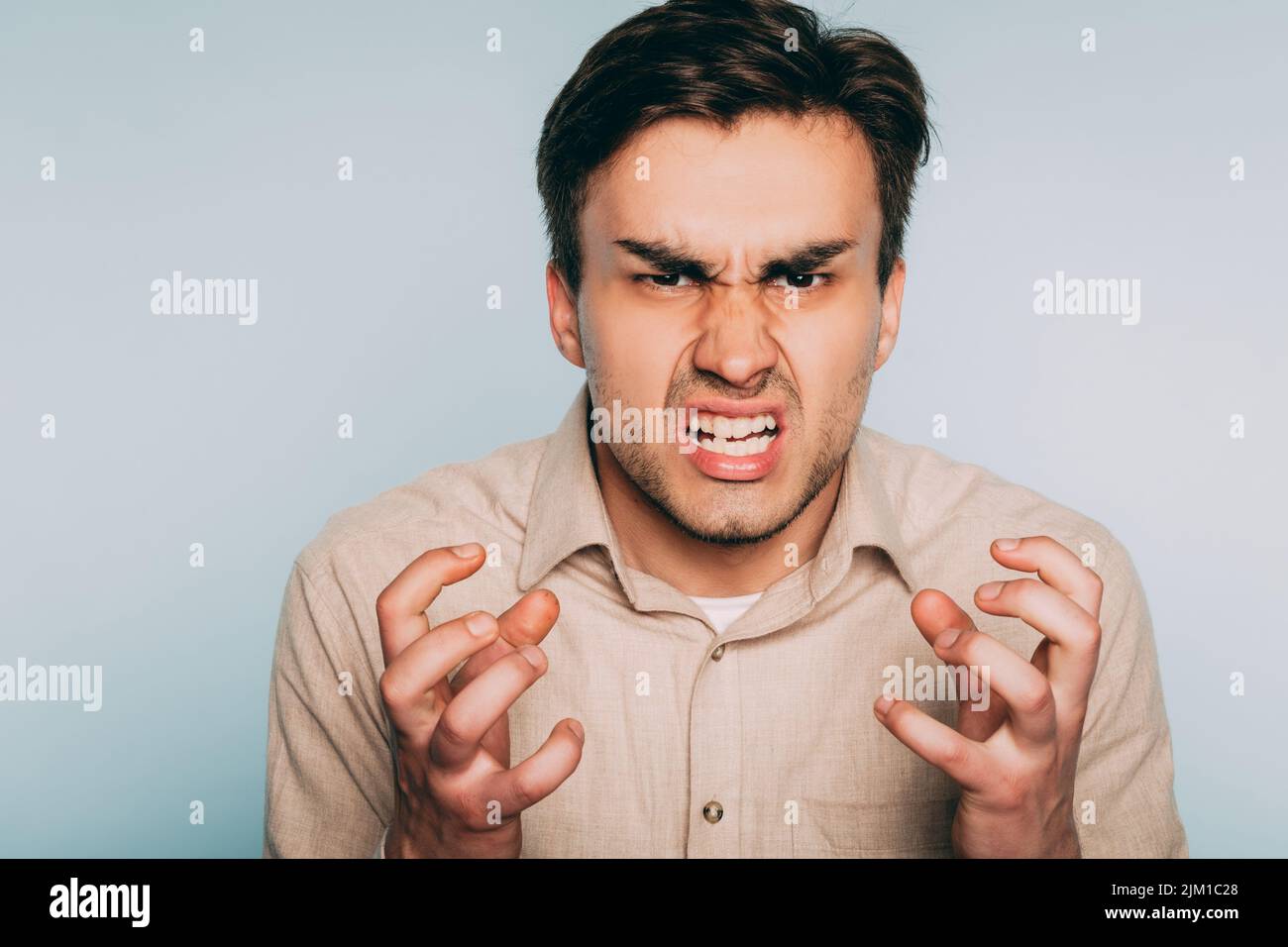 anger rage hatred infuriated man baring teeth Stock Photo