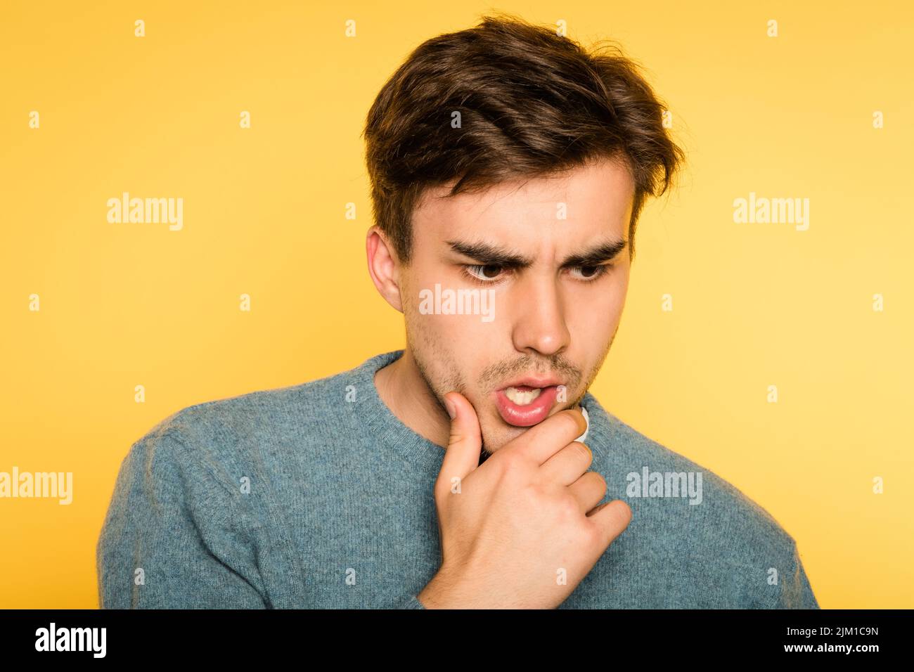 worried distracted pensive man scratch chin think Stock Photo