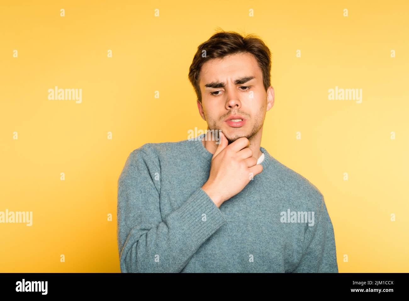 puzzled bewildered man think scratch beard emotion Stock Photo