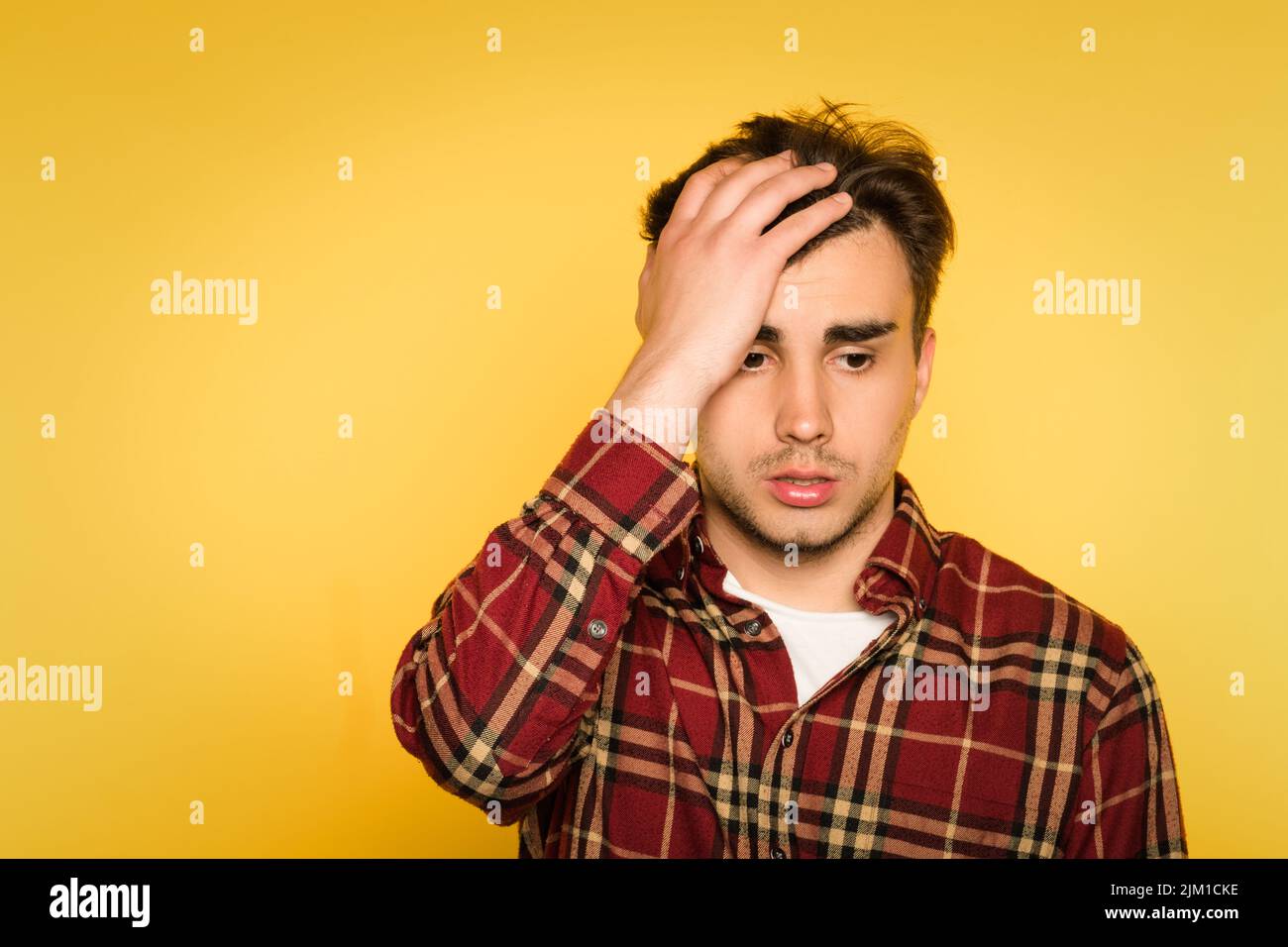 regret remorse dismay man emotion clutch head Stock Photo