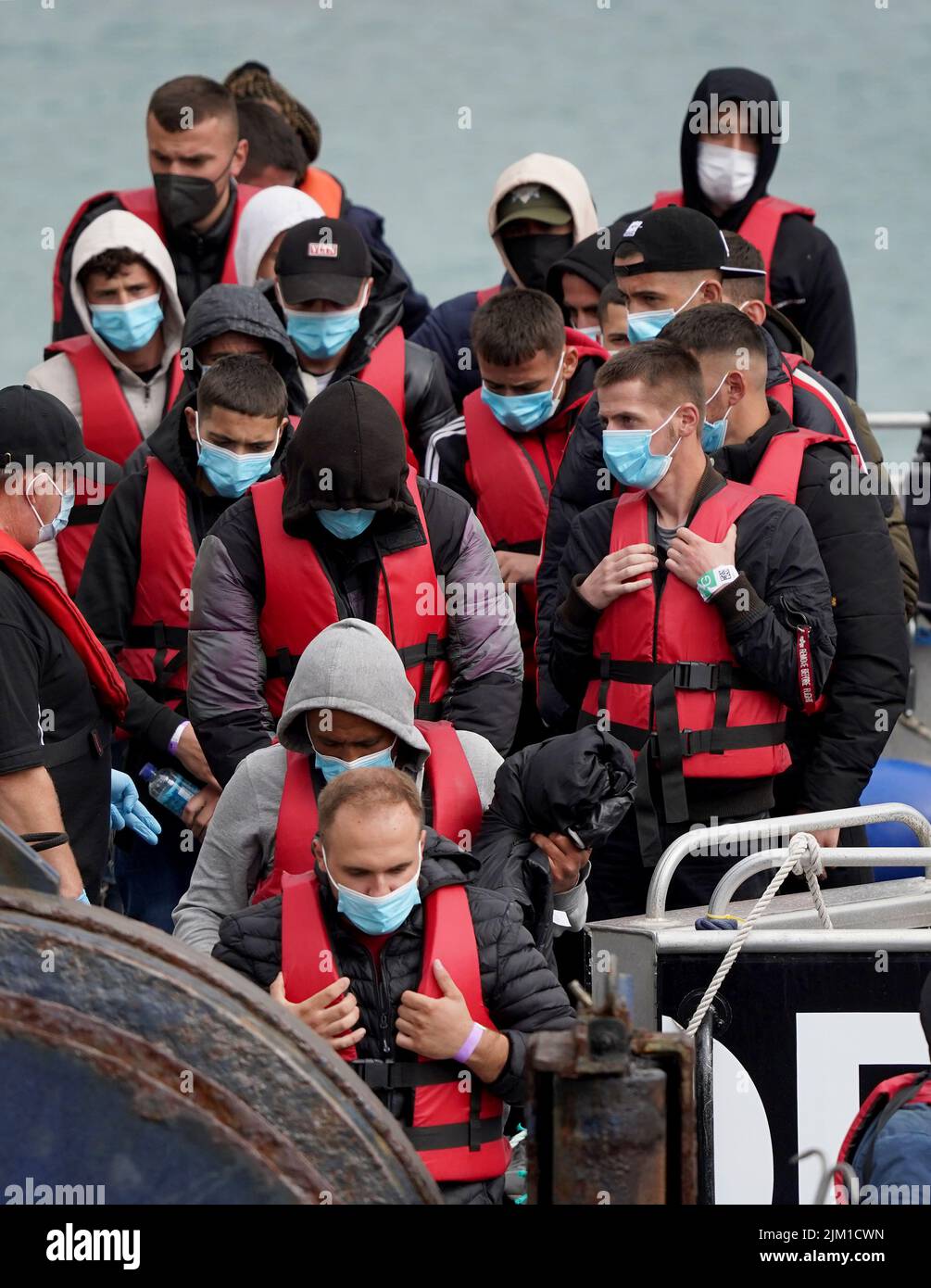 A group of people thought to be migrants are brought in to Dover, Kent, onboard a Border Force vessel following a small boat incident in the Channel. Picture date: Thursday August 4, 2022. Stock Photo