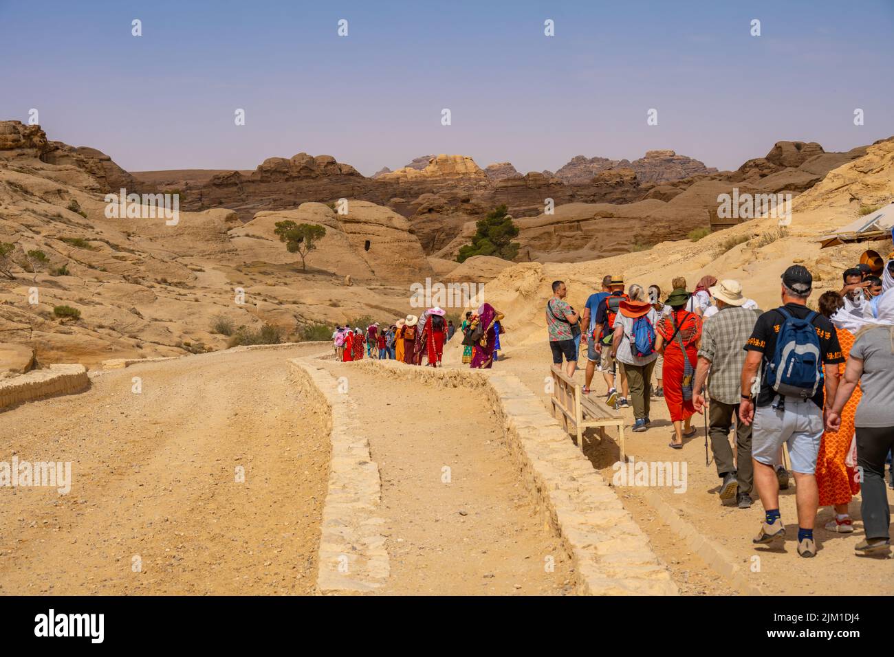 Crowds of people walking down the entrance road to Al-Siq and Petra in Wadi Musa Jordan Stock Photo