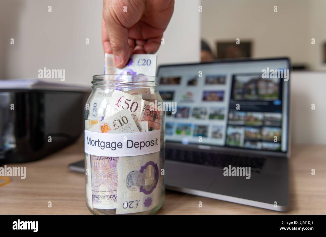 A person saving money towards a mortgage deposit in order to get on the property ladder and buy a home. Stock Photo