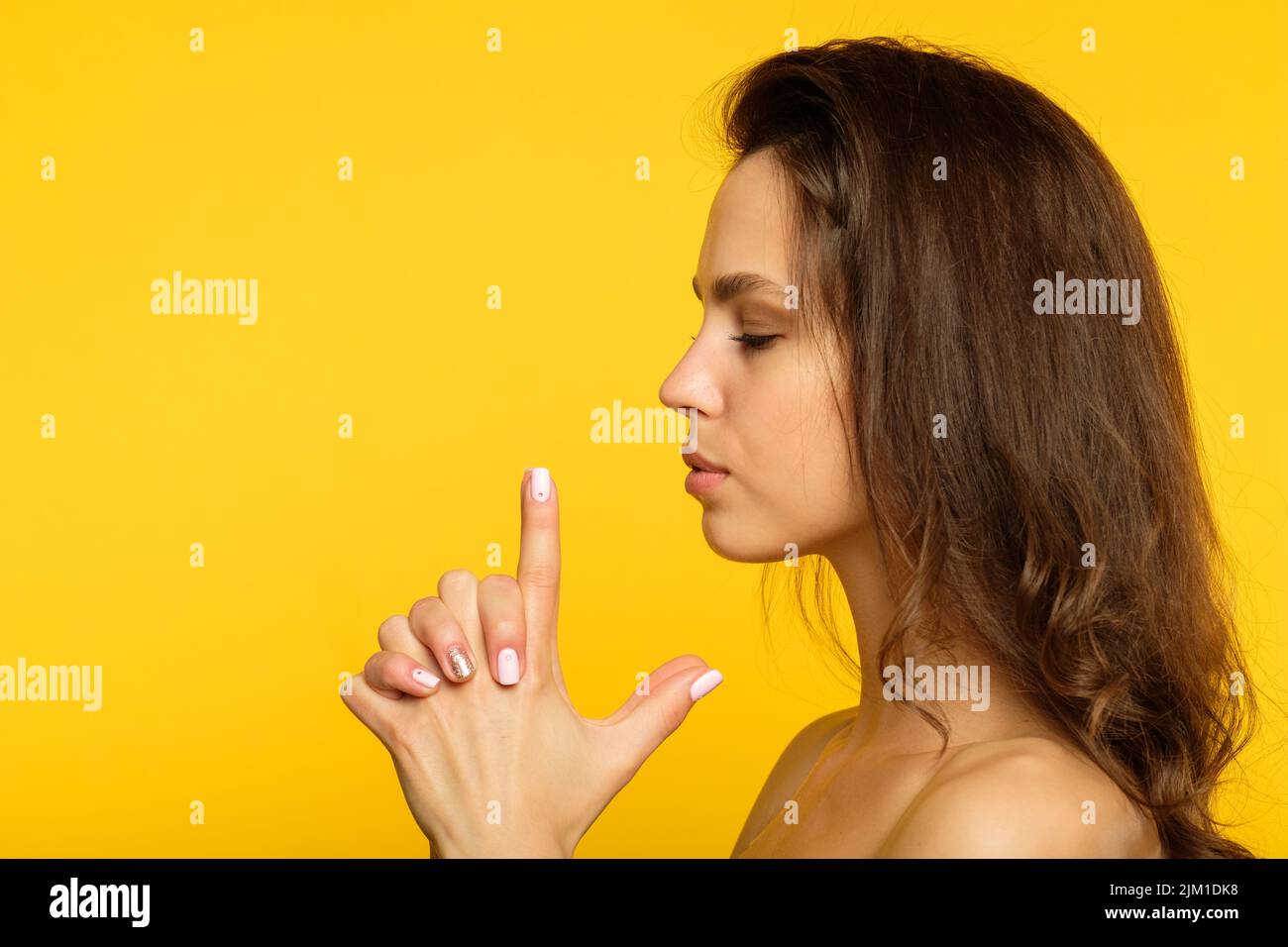 female spy finger gun confident determined woman Stock Photo