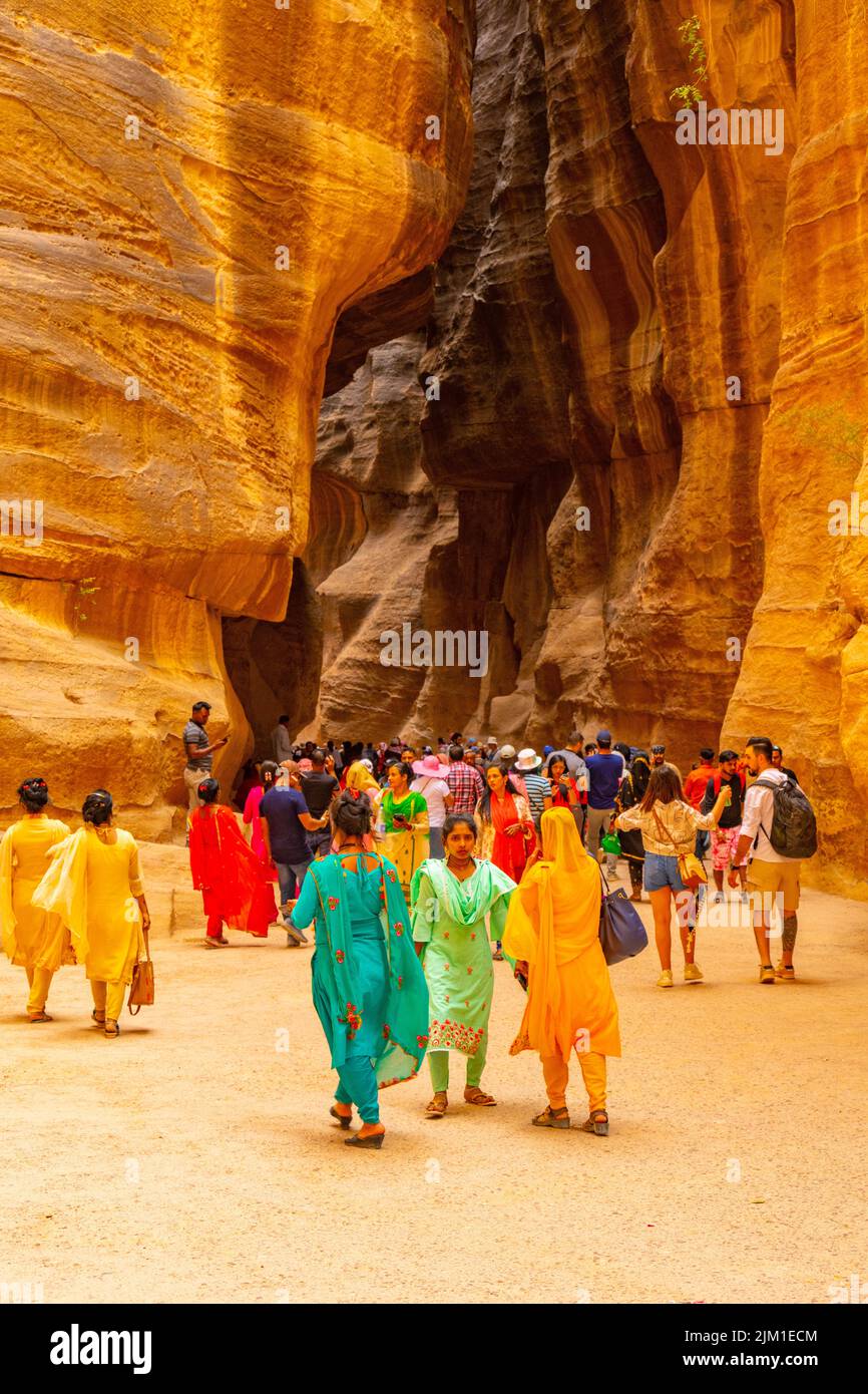 Crowds walking down Al-Siq canyon. The entrance to Petra Jordan. Stock Photo