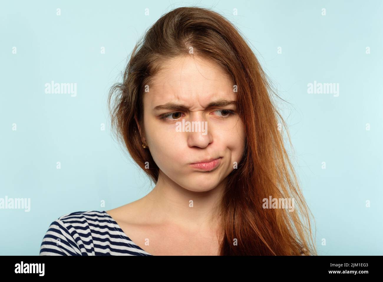 displeased capricious moody girl pursed lips Stock Photo