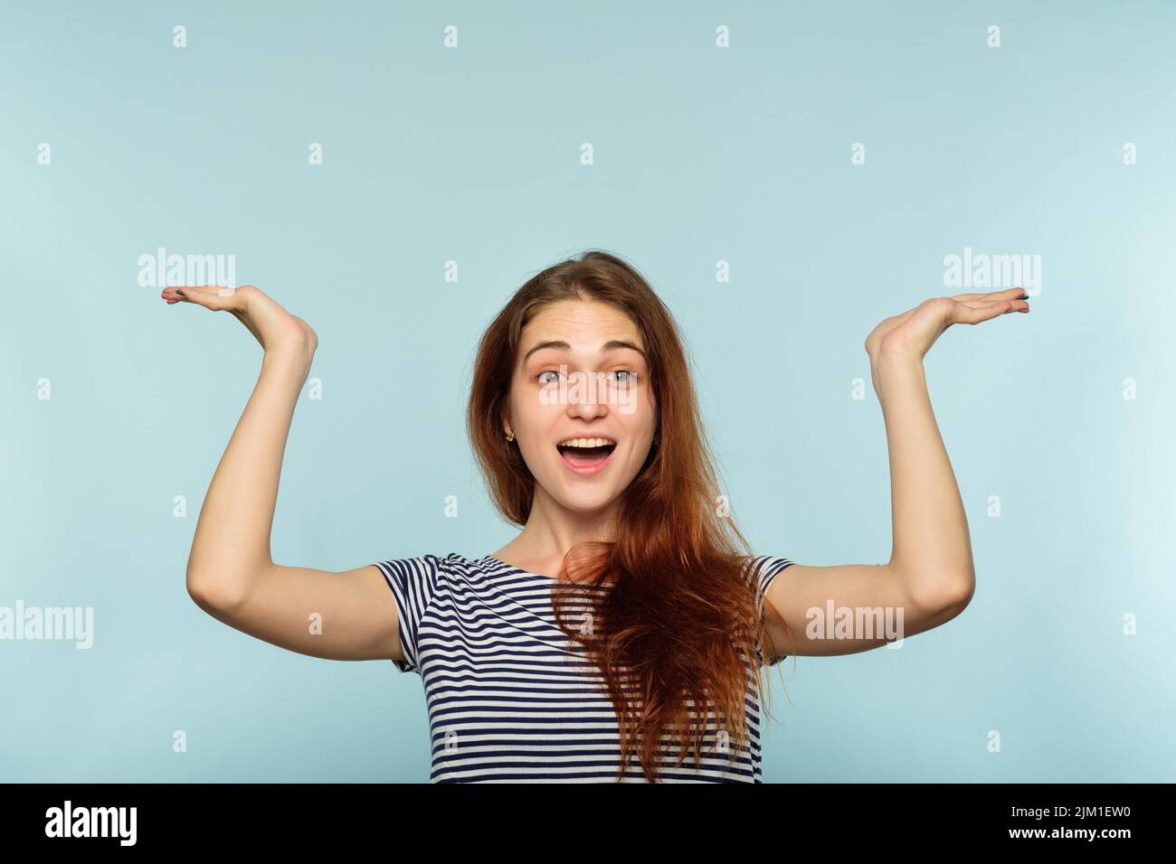 happy joyful surprised girl point up above head Stock Photo