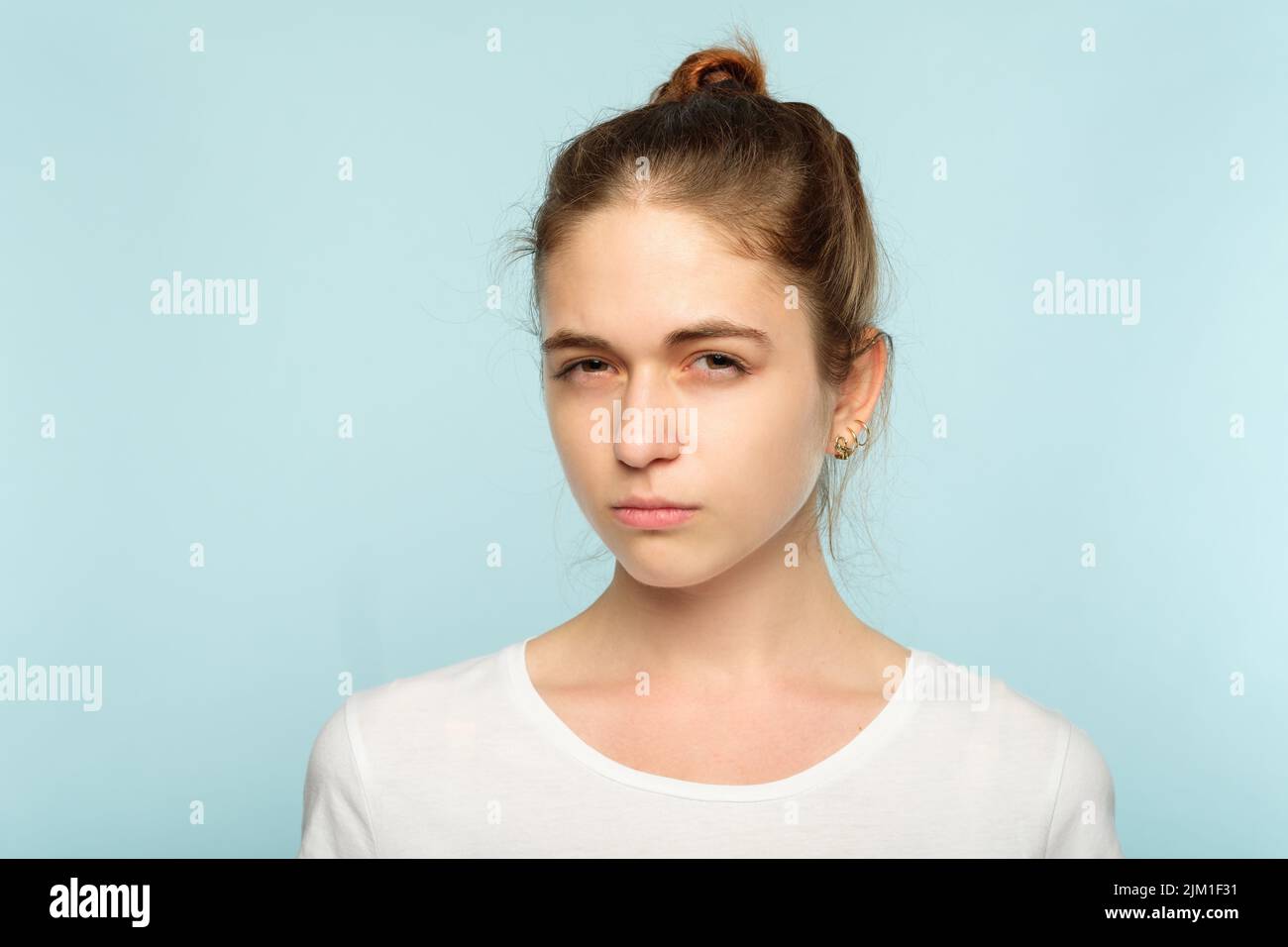 suspicious squinting doubtful girl face expression Stock Photo - Alamy