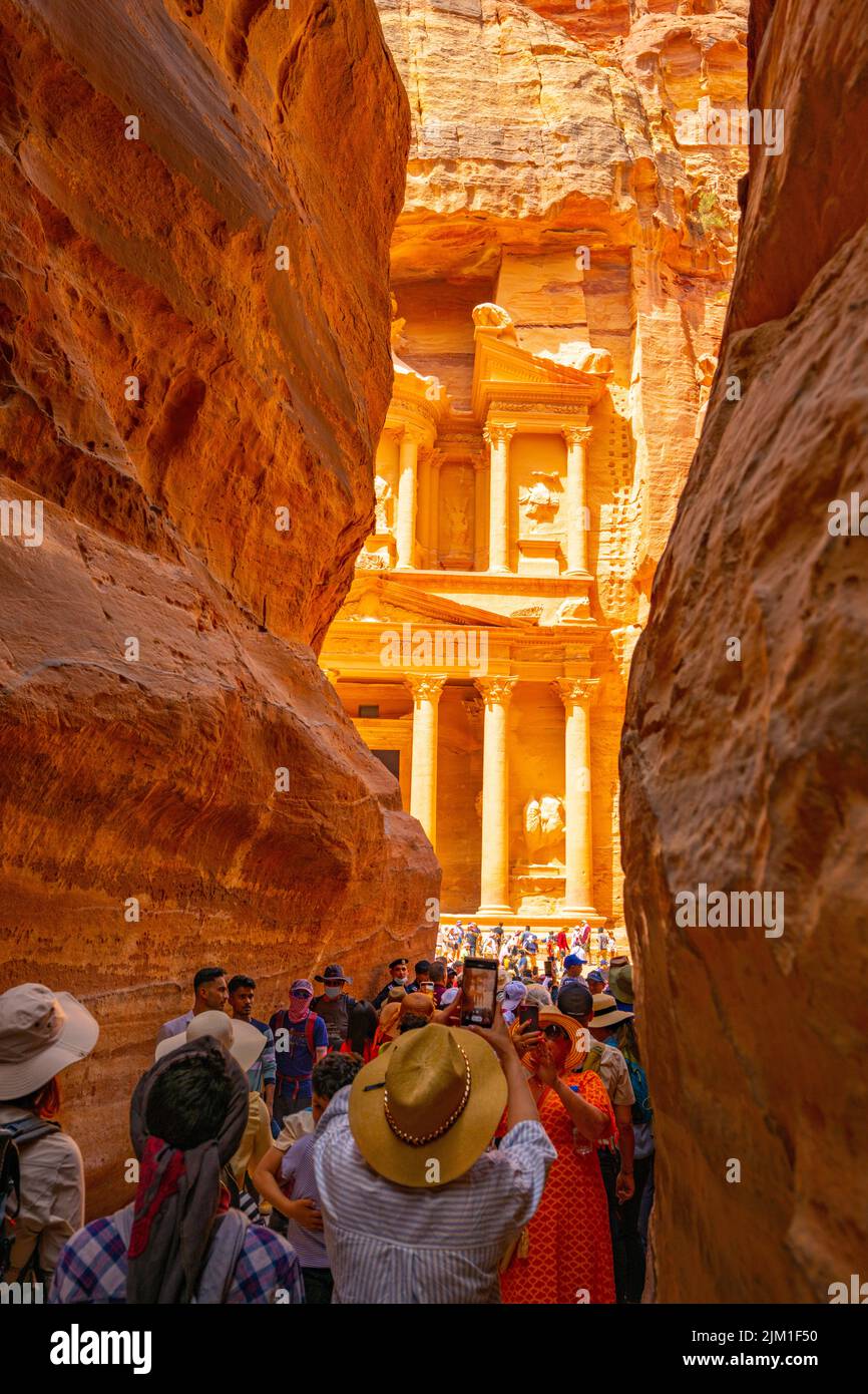 Crowds looking at the first glimpse of the Treasury building from Al Siq in Petra Jordan. Stock Photo